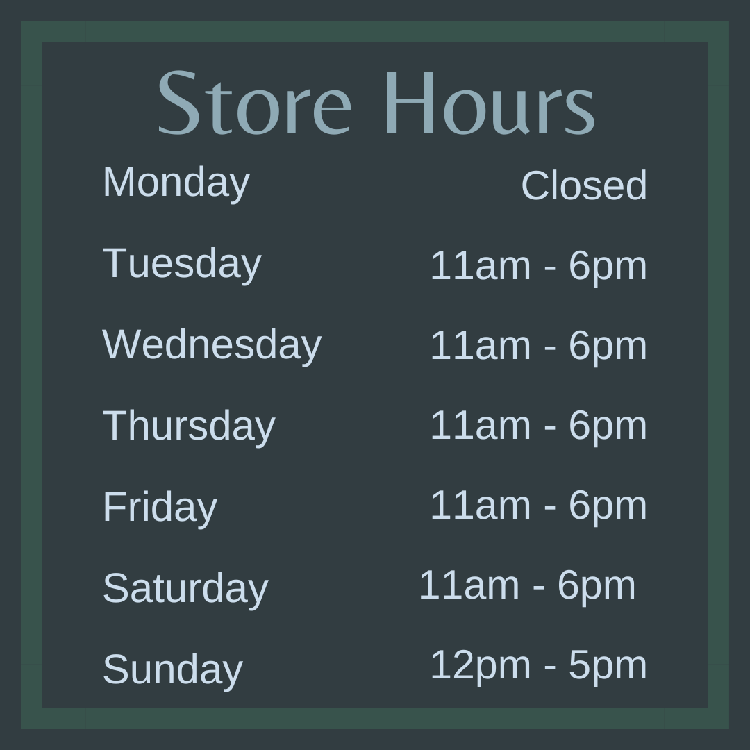 Image shows a blue wood textured background with Cherry blossoms around the side. Test on the image says: Store Hours:  Monday - CLOSED<br />
Tuesday - 11am to 5pm<br />
Wednesday - 11am to 5pm<br />
Thursday - 11am to 5pm<br />
Friday - 11am to 5pm<br />
Saturday - 11am to 5pm<br />
Sunday - 12pm to 5pm